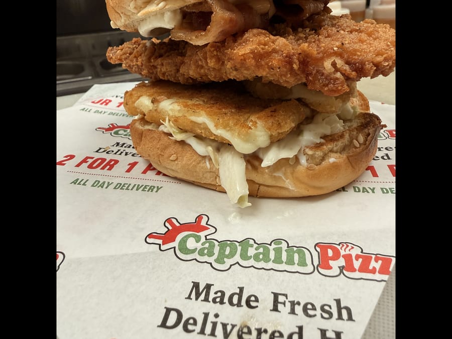 Crispy chicken club burger on Captain Pizza paper