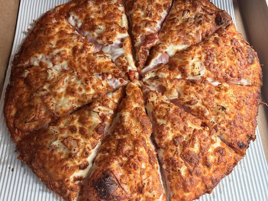 Ham and pineapple pizza, sliced