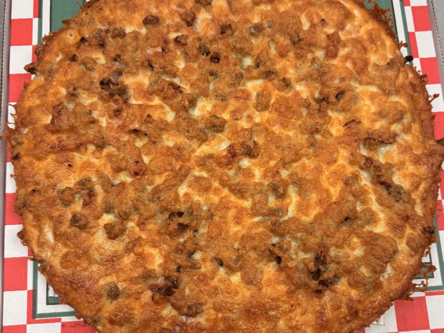 All-meat pizza on the red checkered liner