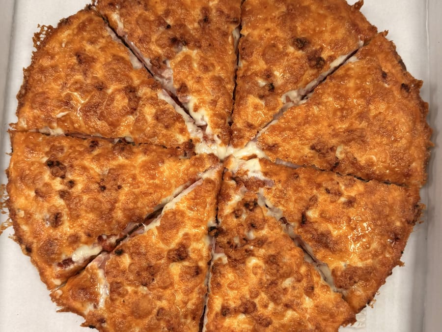 A pizza sliced and ready to box